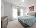 Bright bedroom featuring a comfortable bed, a dresser, and large windows with curtains at 1108 Longwood Ct, Matthews, NC 28104