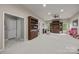 Spacious bonus room featuring built-in bookshelves, recessed lighting, and neutral carpeting at 1108 Longwood Ct, Matthews, NC 28104