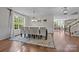 Bright dining room with hardwood floors, large windows, and an elegant chandelier, ideal for entertaining guests at 1108 Longwood Ct, Matthews, NC 28104