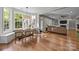 Spacious dining room with hardwood floors and large windows providing natural light at 1108 Longwood Ct, Matthews, NC 28104