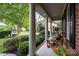 Inviting front porch featuring classic columns, comfortable seating, and lush landscaping, perfect for relaxing outdoors at 1108 Longwood Ct, Matthews, NC 28104