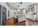 Bright kitchen featuring white cabinetry, a large granite island with seating, and stainless steel appliances at 1108 Longwood Ct, Matthews, NC 28104