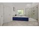 Elegant bathroom with a soaking tub, glass-enclosed shower, and neutral color scheme at 1108 Longwood Ct, Matthews, NC 28104