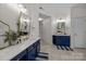 Main bathroom with double sinks, sleek countertops, and blue cabinets at 1108 Longwood Ct, Matthews, NC 28104