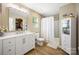 Well-lit bathroom features a modern vanity, walk-in shower with white tiles, and plenty of storage at 1125 Jasmine Dr, Fort Mill, SC 29707