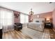 Stylish bedroom features a neutral color palette, a large bed, and ample natural light from the large windows at 1125 Jasmine Dr, Fort Mill, SC 29707