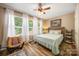 Bright bedroom features a comfortable bed, ample natural light, and a cozy reading chair at 1125 Jasmine Dr, Fort Mill, SC 29707