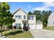 Charming two-story home with a well-manicured lawn and two-car garage on a sunny day at 1125 Jasmine Dr, Fort Mill, SC 29707