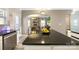 Kitchen with black countertops and island, stainless appliances, opens to the living room at 1125 Jasmine Dr, Fort Mill, SC 29707