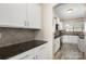 Galley kitchen featuring white cabinets, granite countertops, stainless steel appliances at 1125 Jasmine Dr, Fort Mill, SC 29707
