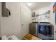 Functional laundry room equipped with modern washer and dryer units, and ample storage shelves at 1125 Jasmine Dr, Fort Mill, SC 29707