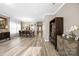 Spacious living room with wood floors and modern furniture, adjacent to a dining area at 1125 Jasmine Dr, Fort Mill, SC 29707