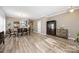 Bright and airy living room featuring hardwood floors, a dining table, and elegant decor at 1125 Jasmine Dr, Fort Mill, SC 29707