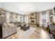 Bright living room with stone fireplace, wood floors, and large sectional sofa at 1125 Jasmine Dr, Fort Mill, SC 29707