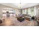 Inviting open-concept living room with kitchen view, wood floors, and ample natural light at 1125 Jasmine Dr, Fort Mill, SC 29707