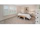 Bright bedroom with large windows, a plush carpet, and a white bench at the foot of the bed at 113 Callandor Ct, Troutman, NC 28166
