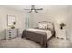 Cozy bedroom with a decorative metal headboard bed, soft carpet, and bright natural light from the window at 113 Callandor Ct, Troutman, NC 28166