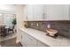 Elegant butler pantry featuring white cabinets, quartz countertops, and stylish gray subway tile at 113 Callandor Ct, Troutman, NC 28166