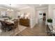 Elegant dining room with hardwood floors, modern lighting, wainscoting, and neutral decor at 113 Callandor Ct, Troutman, NC 28166