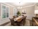 Cozy dining room featuring six upholstered chairs, a wooden table, and stylish window shutters at 113 Callandor Ct, Troutman, NC 28166