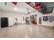 Spacious garage with coated floors, storage racks, and ample space for vehicles and equipment at 113 Callandor Ct, Troutman, NC 28166