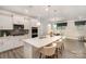 Bright kitchen featuring white cabinets, a large center island, and modern stainless steel appliances at 113 Callandor Ct, Troutman, NC 28166