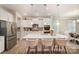 Modern kitchen featuring a large island with pendant lighting, stainless steel appliances, and bar seating at 113 Callandor Ct, Troutman, NC 28166