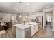 Bright open kitchen featuring white cabinets, stainless appliances, and a stylish island at 113 Callandor Ct, Troutman, NC 28166