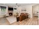 Comfortable living room boasts a stone fireplace, large windows, and a ceiling fan at 113 Callandor Ct, Troutman, NC 28166