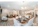 Open-concept living space features the kitchen, dining area, and Gathering room with stairs to the second story at 113 Callandor Ct, Troutman, NC 28166