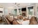 Open living space has a stone fireplace, large windows, and seamlessly connects to the dining area at 113 Callandor Ct, Troutman, NC 28166