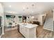 Open-concept living space with modern kitchen, dining area, living room, and staircase at 113 Callandor Ct, Troutman, NC 28166