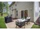 Back patio with outdoor seating and a grill, perfect for enjoying the backyard view and outdoor cooking at 113 Callandor Ct, Troutman, NC 28166