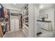 Organized walk-in closet with custom shelving, drawers, and a convenient laundry area at 113 Callandor Ct, Troutman, NC 28166