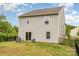Back of house showing sliding glass door, backyard with fence and gentle sloped hill at 1313 Forkhorn Dr, Monroe, NC 28110