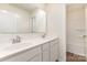 Bathroom featuring a double sink vanity and view to the toilet and shower/tub, offering convenience and functionality at 1313 Forkhorn Dr, Monroe, NC 28110