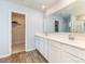 Bathroom features double sink vanity with white cabinets and a large mirror, plus a walk in closet at 1313 Forkhorn Dr, Monroe, NC 28110