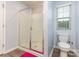 Bathroom featuring a glass enclosed shower, toilet and window at 1313 Forkhorn Dr, Monroe, NC 28110