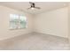 Bright bedroom showcasing a large window that lets in natural light and neutral carpeting at 1313 Forkhorn Dr, Monroe, NC 28110