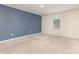 Inviting bedroom with a calming accent wall, natural light and neutral carpet flooring at 1313 Forkhorn Dr, Monroe, NC 28110