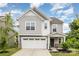 Beautiful two-story home with a two-car garage, stone accents, and a covered front entry at 1313 Forkhorn Dr, Monroe, NC 28110