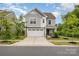 Attractive two-story home with a two-car garage, easy driveway access and lovely curb appeal at 1313 Forkhorn Dr, Monroe, NC 28110