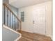 Inviting entryway with wood-look flooring, stairs, and a bright, white front door at 1313 Forkhorn Dr, Monroe, NC 28110