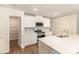 Clean and modern kitchen with white cabinets and stainless steel appliances, with a view of pantry at 1313 Forkhorn Dr, Monroe, NC 28110