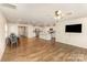 Open-concept living room with hardwood floors and a modern kitchen in a bright and airy space at 1313 Forkhorn Dr, Monroe, NC 28110