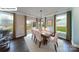 Dining room features large windows overlooking the yard, a modern chandelier, and neutral decor at 140 Ventor Way, Mooresville, NC 28115