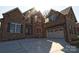 Handsome brick home with a wide driveway, attached two-car garage, and well-maintained landscaping at 1921 Notchwood Ct, Clover, SC 29710