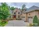 Elegant home with a meticulously kept lawn, complemented by the charming curb appeal of the landscaping at 1921 Notchwood Ct, Clover, SC 29710