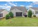 Spacious backyard with well-maintained lawn and a screened patio perfect for outdoor gatherings at 2035 Moultrie Ct, Fort Mill, SC 29707