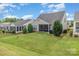 Backyard view of a home featuring a screened-in porch and well-manicured lawn at 2035 Moultrie Ct, Fort Mill, SC 29707